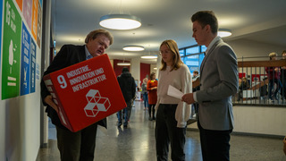 Herr Voussem mit Schülerin und Schüler im Gespräch.